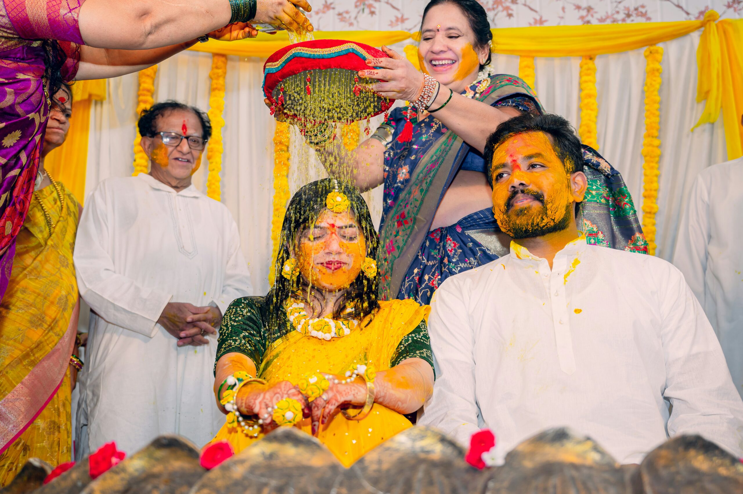 Bride covered in turmeric during joyful Haldi ceremony – Skumar Films