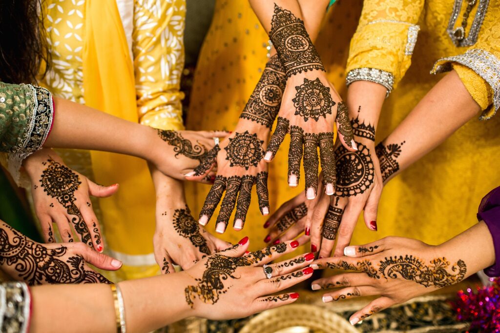 Best Wedding Photographer in Prayagraj – Capture Your Dream Wedding with SKumar Films 7 Bride getting intricate mehndi applied to hands before wedding ceremony
